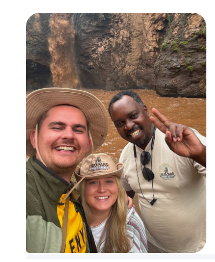 James Lewis and his wife on honeymoon with Paul, their Leopard Orchid Safaris guide, by a waterfall